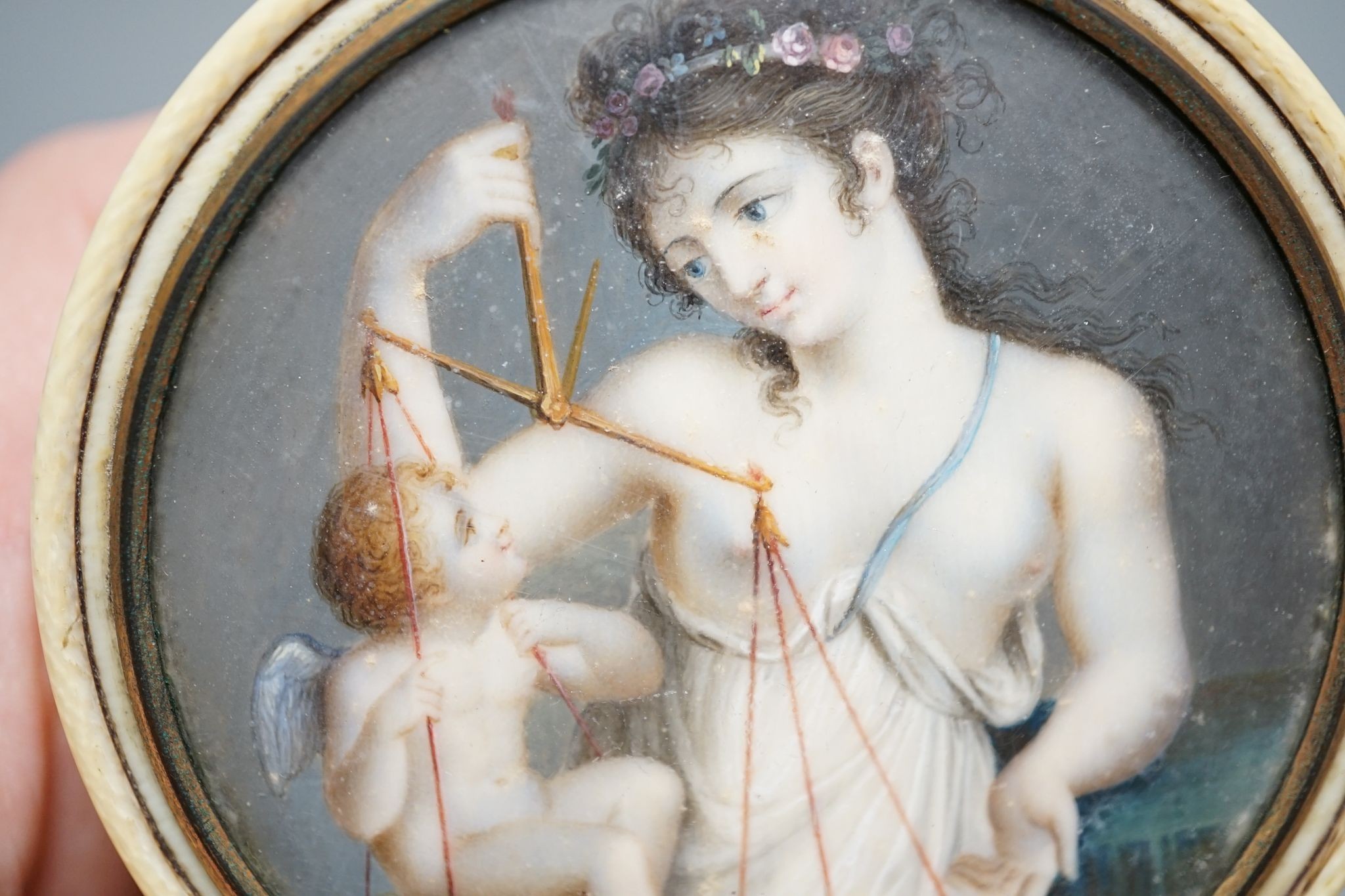 An early 19th century ivory and tortoishell box with inset miniature of Themis to cover, 8cm.